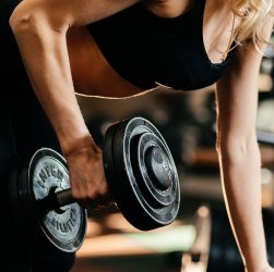Focused woman lifting a dumbbell, highlighting strength and fitness goals. — Buy MK677 Australia: Promoting Muscle Growth and