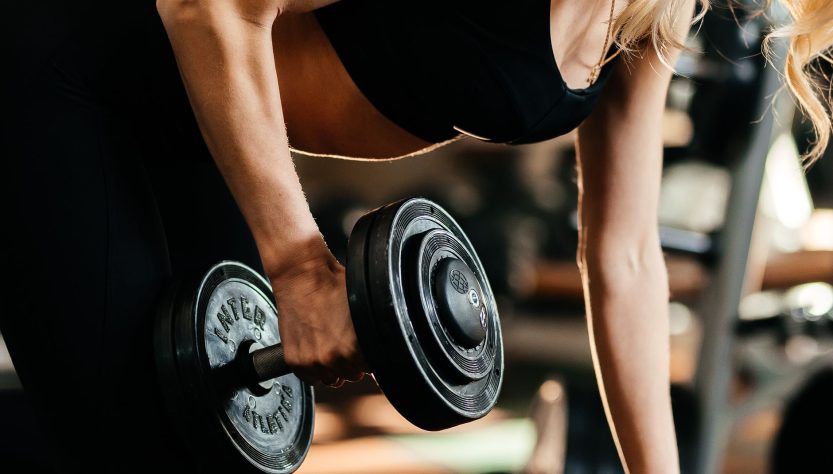 Focused woman lifting a dumbbell, highlighting strength and fitness goals. — Buy MK677 Australia: Promoting Muscle Growth and