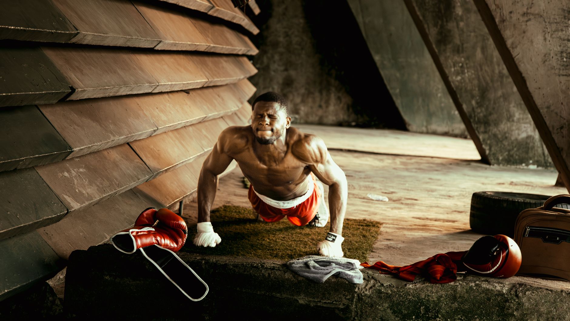 African male boxer doing push-ups in an industrial-style gym setting, showcasing strength and determination. — Can Yoga Help