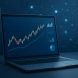 A laptop displaying financial charts and graphs in a dark-themed environment