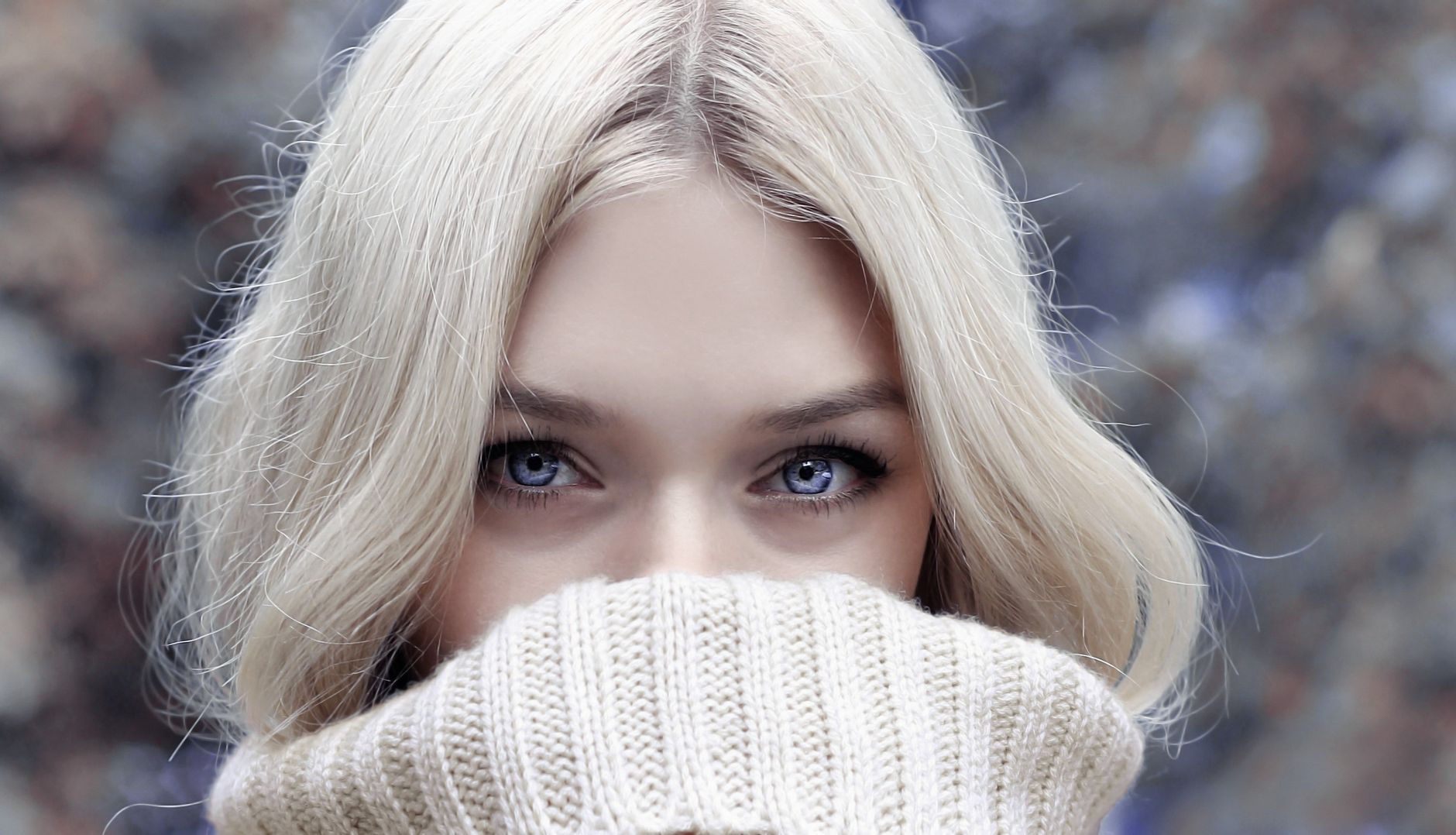 A close-up portrait of a blonde woman in winter attire, emphasizing her eyes. — Right Jawline Filling Options for You