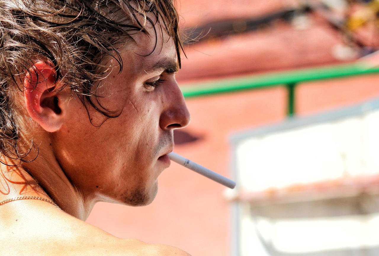 Man, face, cigarette — Substance Use Disorder Aftercare Programs: What You Need to Know